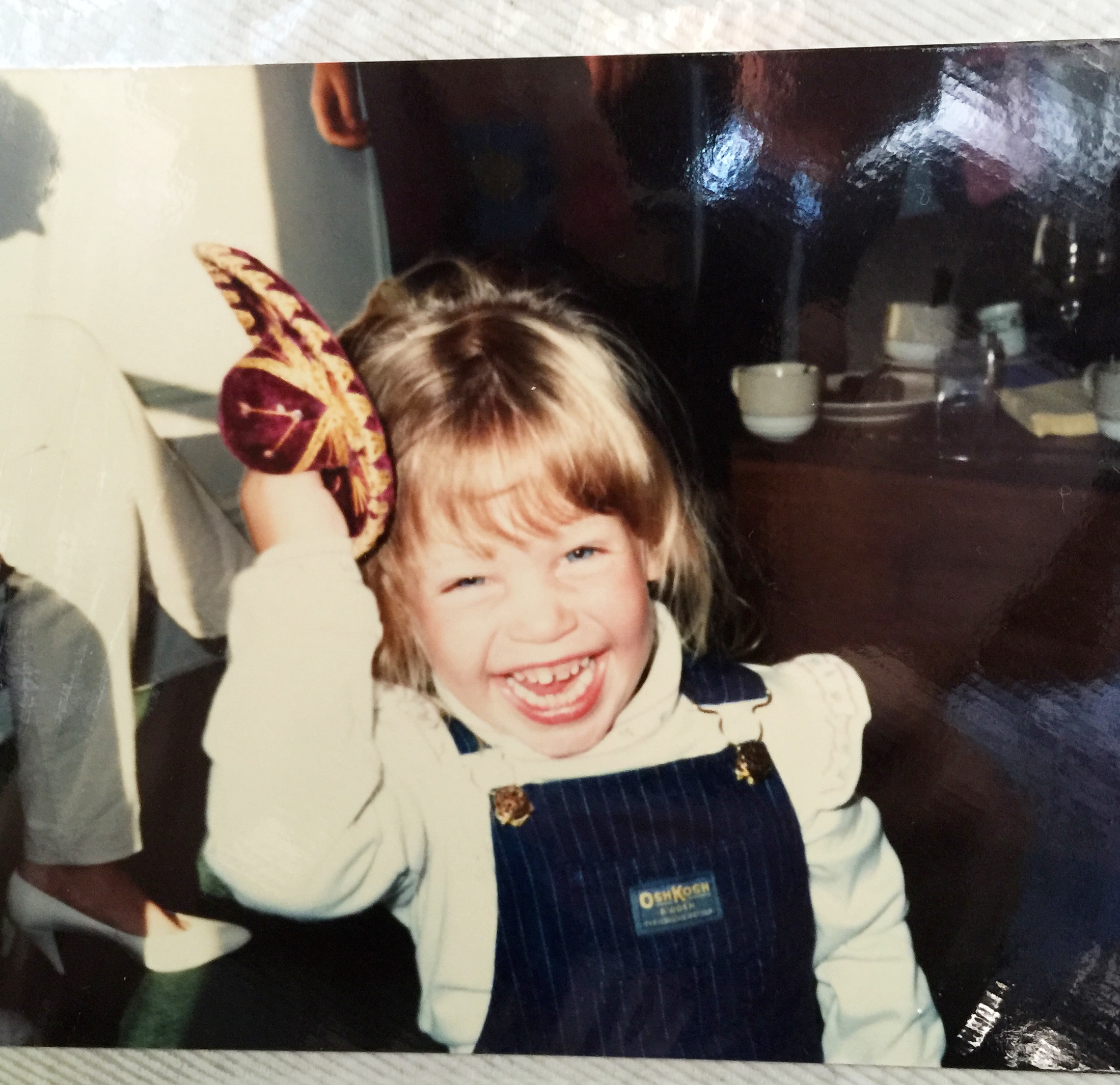 Little girl playing with a toy hat