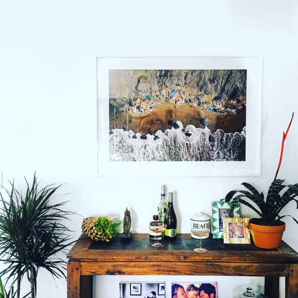 Gray Malin's San Francisco nude beach print over a wood console