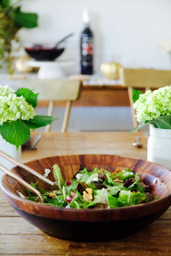 apple, walnut and cherry tossed salad in wooden serving bowl