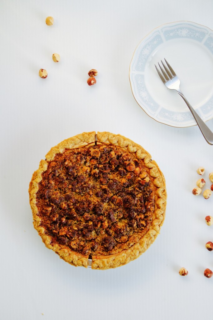 A chocolate hazelnut crostata on a white background