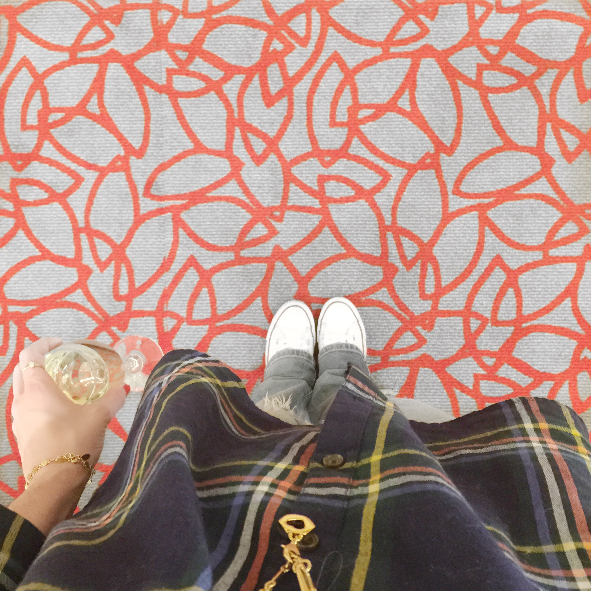 Graphic red and grey carpet and a plaid shirt