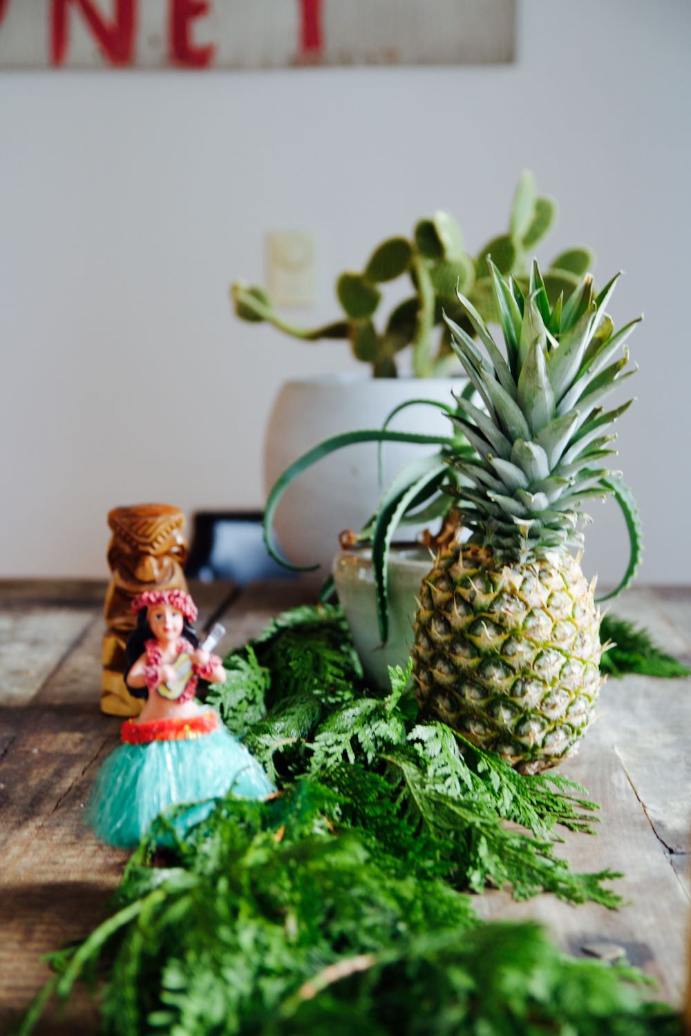 interesting retro holiday tablescape with pineapples and a hulu dancer