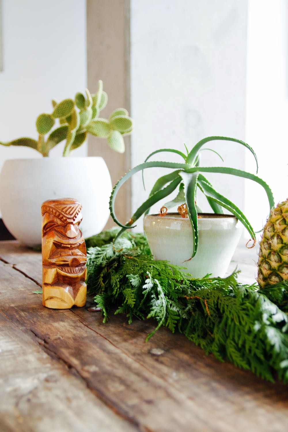 succulents, a tiki cup and a garland for a retro holiday tablescape