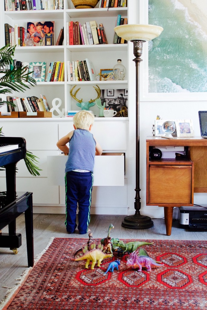 Built-in shelving in a combined office and playroom space