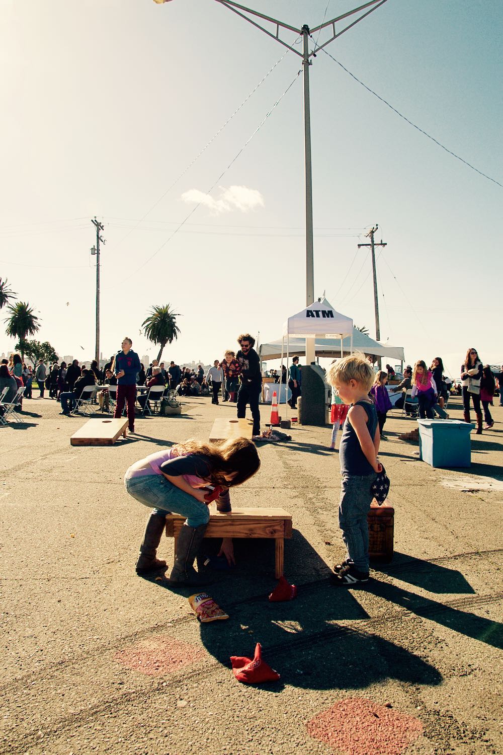 Playing corn hole at the Treasure Island Flea