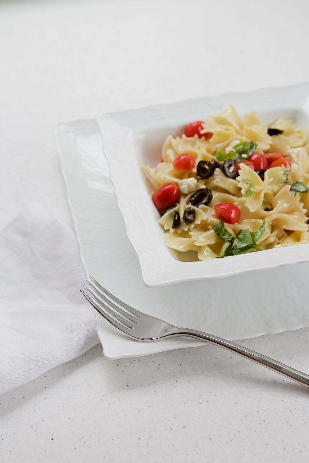 Fearful with tomatoes, olives, basil and cotija cheese