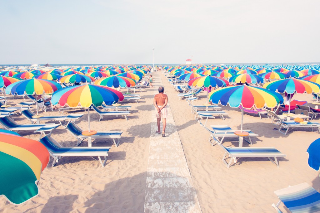 Gray Malin's Riccioni print of old man and rainbow umbrellas