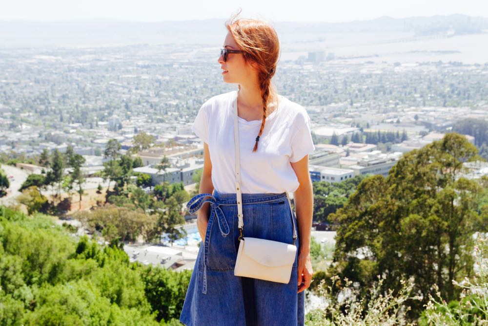 Brie Barbaccia in a white t-shirt and high-waisted denim skirt