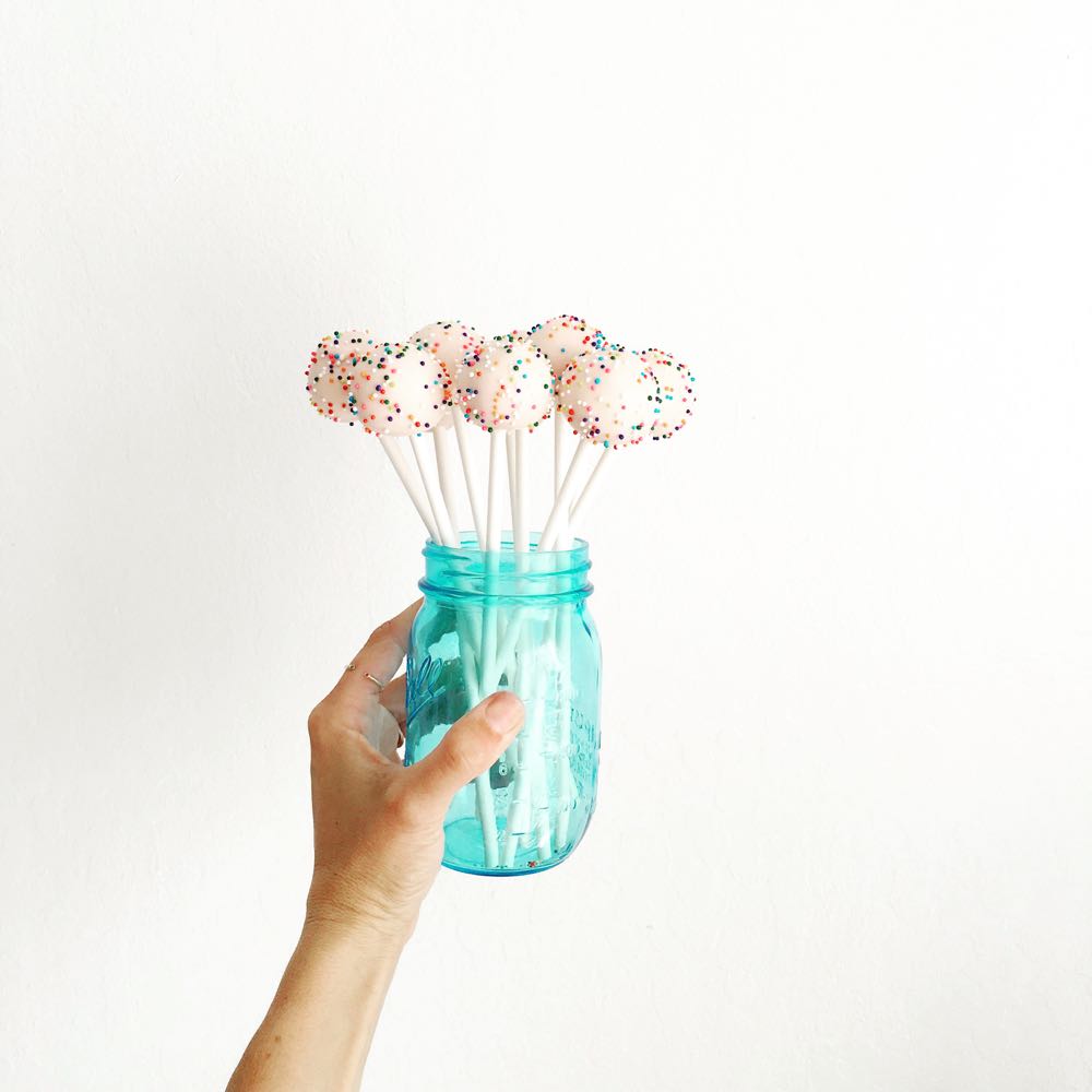 pink cake pops with rainbow sprinkles