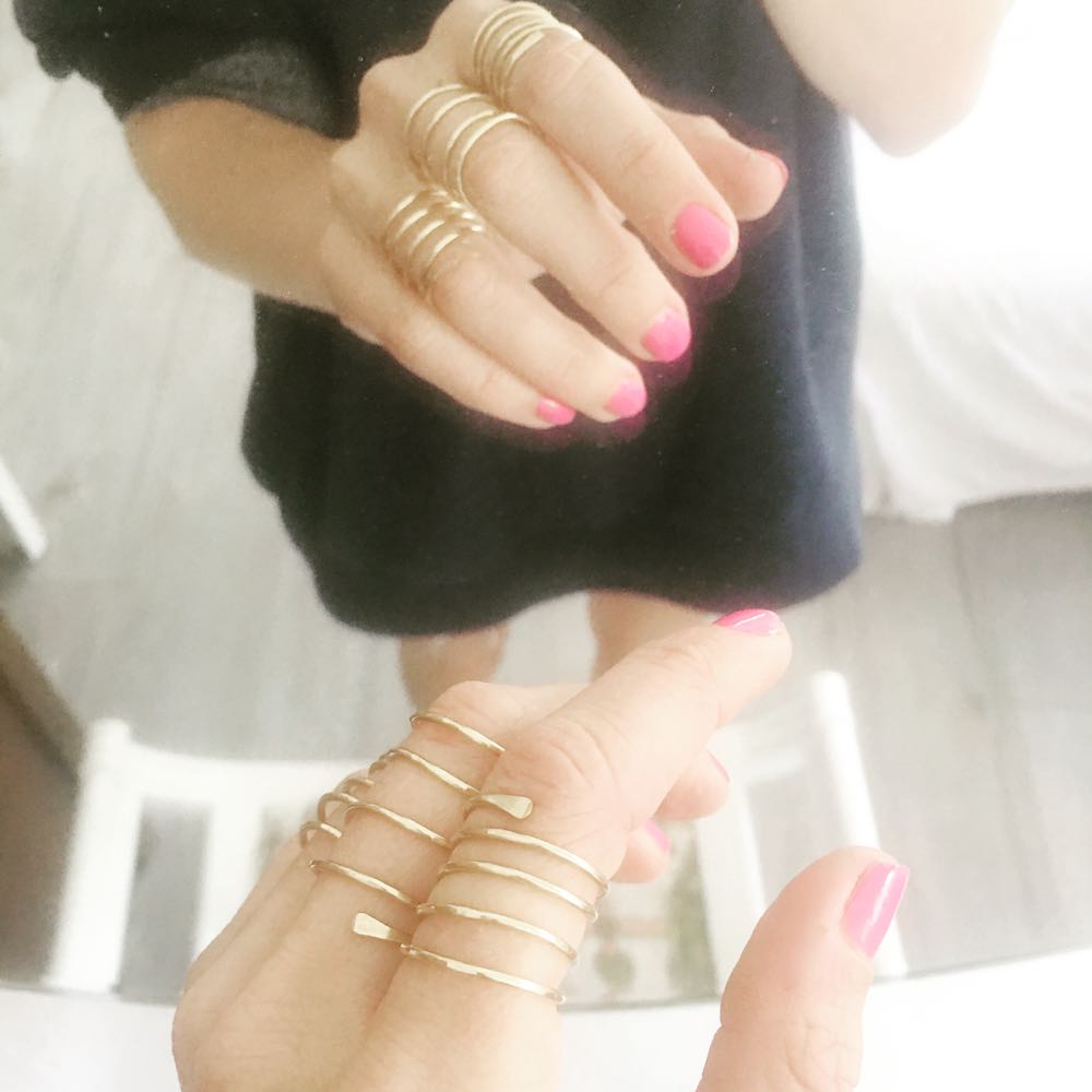 simple gold coil rings for all five fingers
