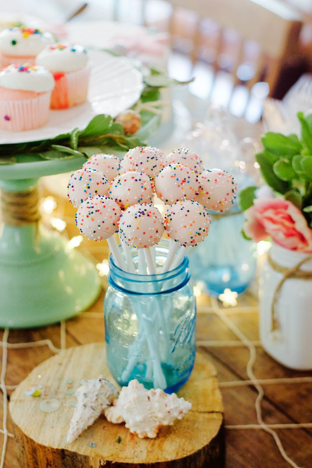 Pink cake pops in a blue mason jar