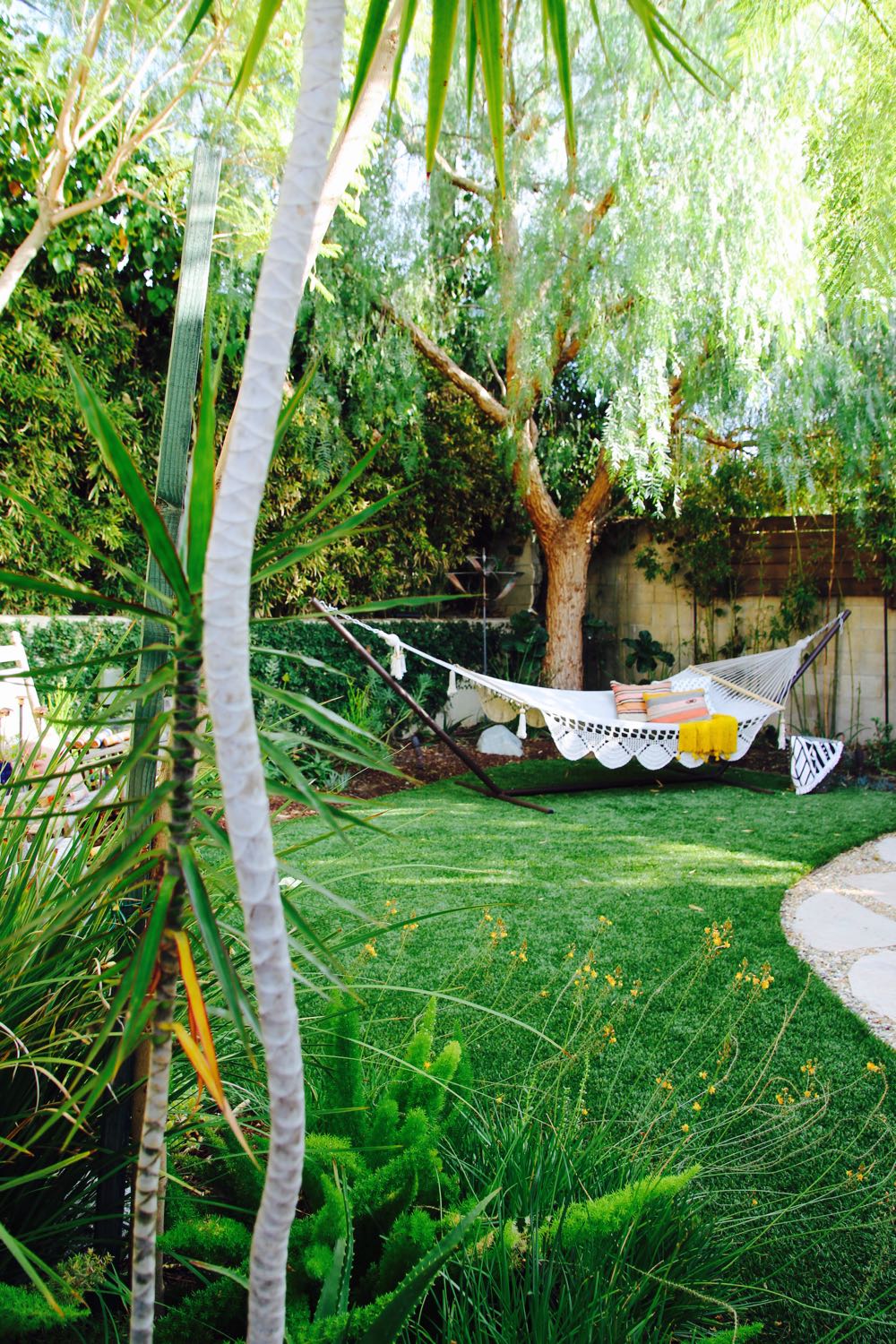 Beautiful boho backyard with tasseled hammock