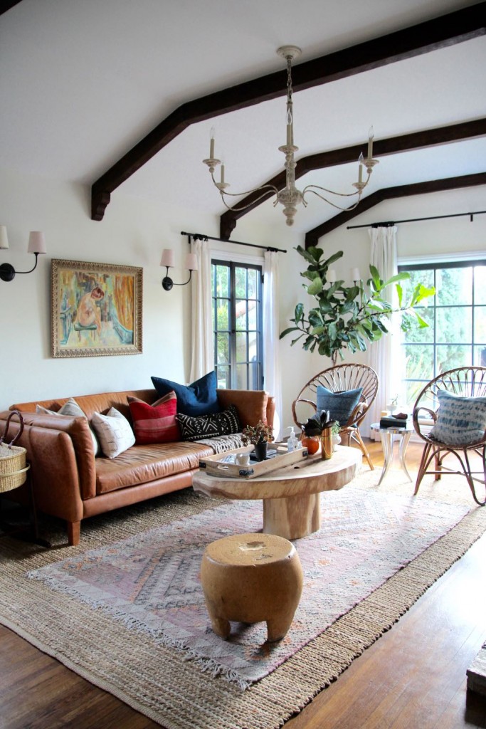 Beautiful living room with exposed arched beams and a leather couch