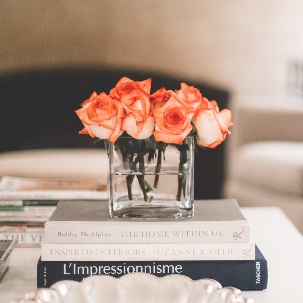 tight bunch of orange roses on a coffee table