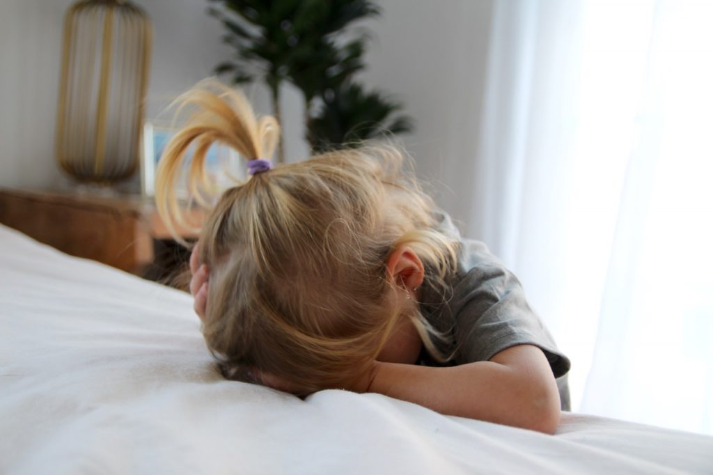 little girl hiding her face