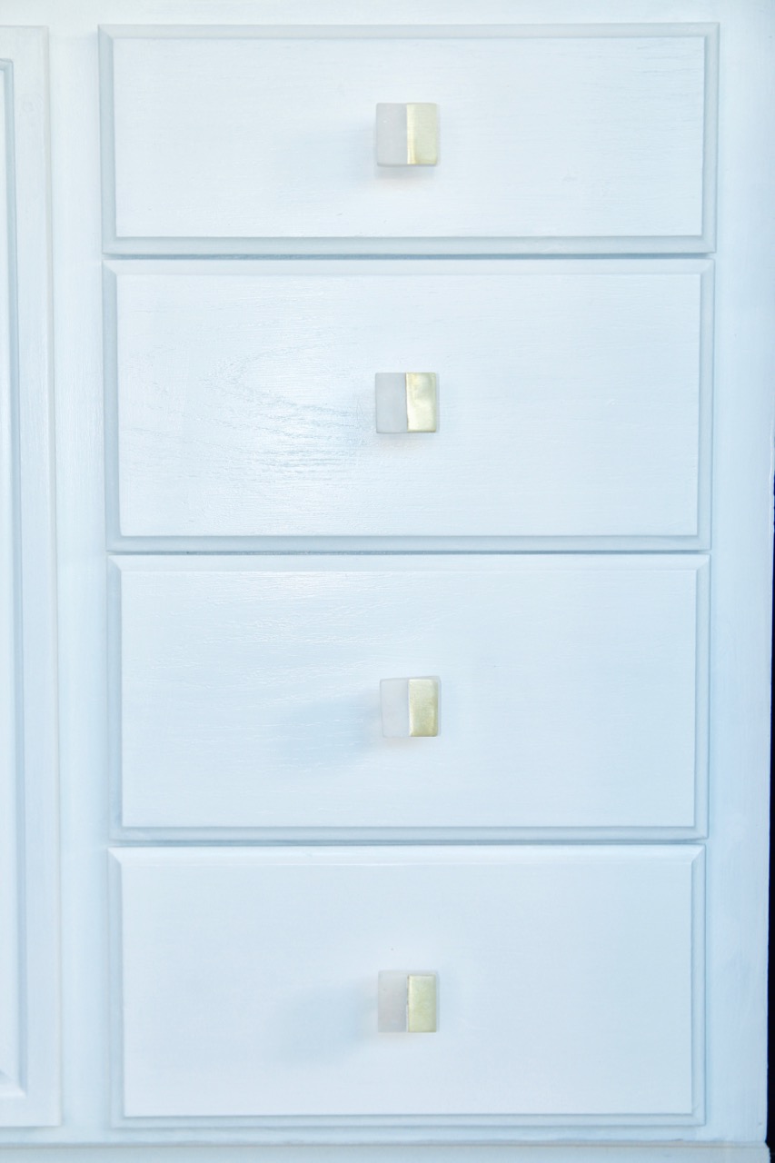 gold and white marble cabinet or drawer pulls