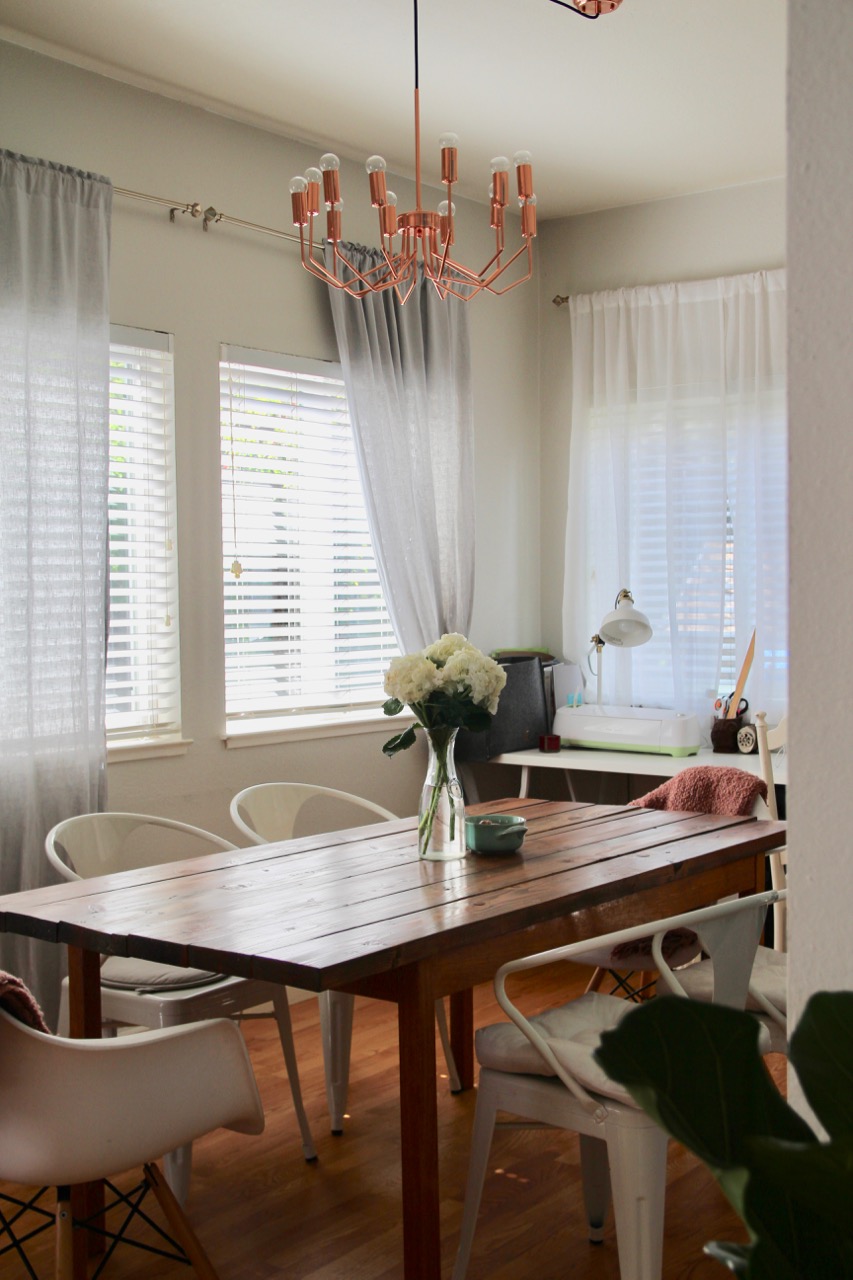 farmhouse dining table in bright dining room