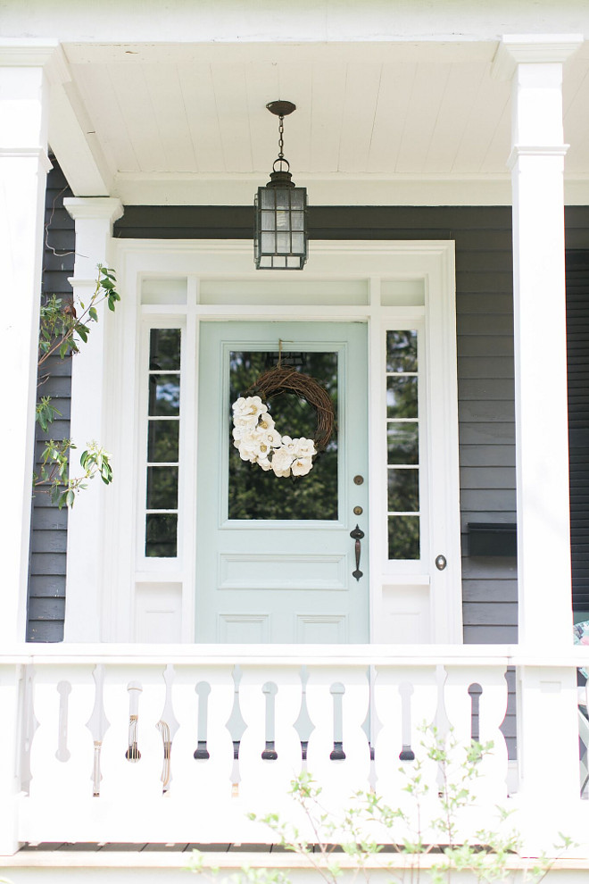 pale blue door with white and grey house