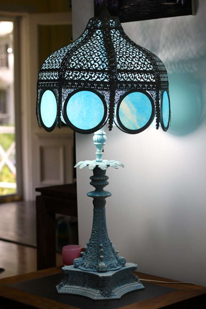 large wrought iron base lamp with translucent blue glass panels