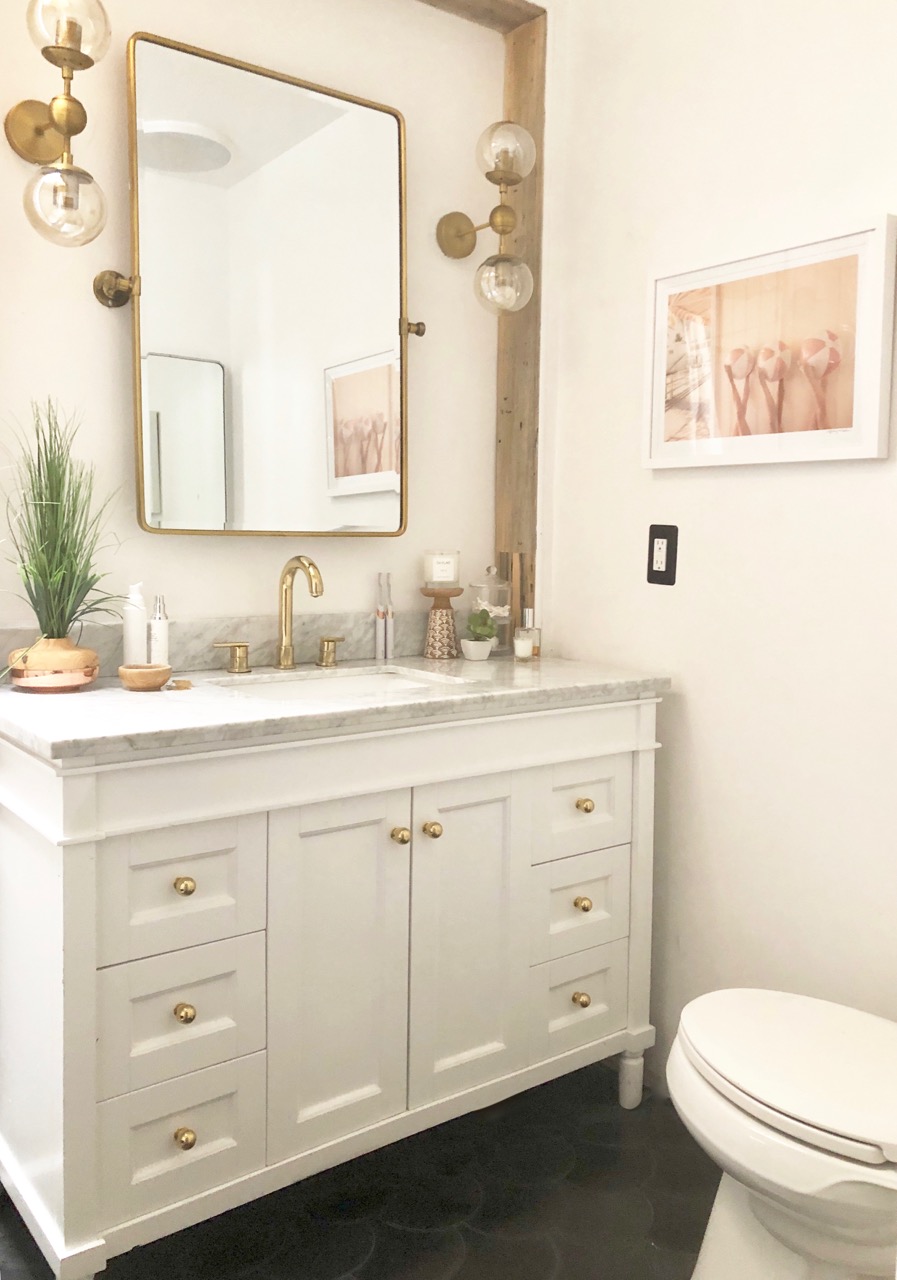 bathroom renovation with black cement tile and white and gold