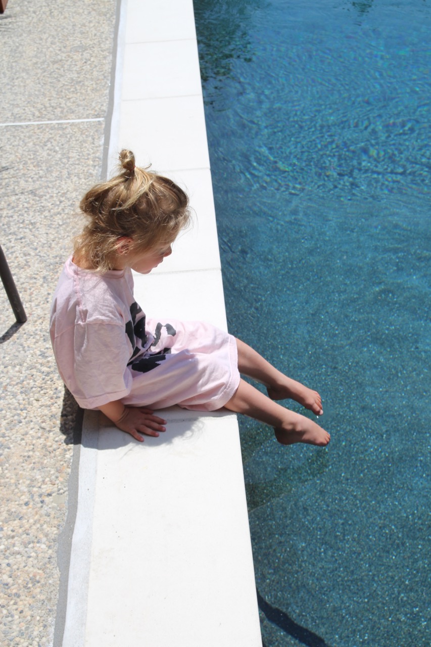 dark blue pool with flat white coping